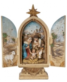 A symbol of the season, a gold star sits atop this Holy Family Trinity figurine where you can open the doors to reveal an intricate painted scene of Bethlehem and the carved figures of Mary and Joseph adoring their newborn baby.