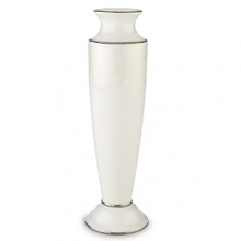 Pearl-like enamel dots enhance a creamy leaf design that encircles the top of this exquisite vase. An opalescent finish provides a lustrous background for the design. And four bands of precious platinum complete the elegant look. The vase makes a lovely bridesmaid gift. Made is crafted of Lenox white bone china and accented with precious platinum.Height: 8 1/8