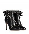 An ultra feminine take on the iconic Valentino look, these rockstud trimmed leather bow boots count as a covetable must - Round toe, back zip, oversized bow on outside with rockstud trim throughout, stiletto heel, rubber insert on sole for traction - Hits above the ankle - Wear with everything from slim fit trousers to tailored sheath dresses