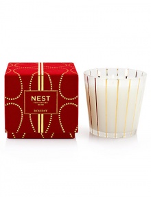 Captures the aroma of a sparkling holiday season. Large, three-wick candle fragranced with inviting notes of pomegranate, mandarin orange, pine, cloves and cinnamon. Housed in an elegant glass vessel and presented in a red velvet box. Created by Laura Slatkin. Approximately 100 hours of burn time. 19.7 oz.