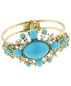 Crazy for cuff's? You'll simply adore 2028's vibrant style. A lovely mix of turquoise acrylic and glass beads create a dazzling effect in a gold tone mixed metal setting. Approximate diameter: 2-1/4 inches.