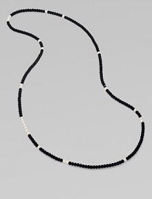 From the Night Blue Collection. This high contrast piece features a long strand of flocked velvet beads punctuated by pearlized glass beads. Length, about 49½ Slip-on style Imported 