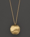 A textured, hand engraved pendant necklace in 18K gold from Marco Bicego.