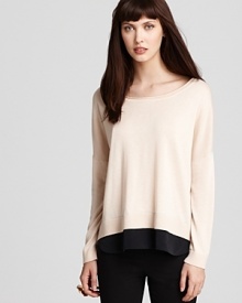 Slouchy with a silk panel peeking out at the hem, this knit sweater makes the perfect balance for skinny pants.