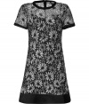 Sophisticated yet feminine dress makes any smart ladies closet complete - Features a black and white woven floral pattern that is romantic and elegant - Vintage cut with small round neck and short sleeves - Slightly flared with an ornamental border, waist darts and back zipper - Style with mules or sling backs and under a trench coat, blazer or cardigan