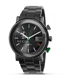 A black bracelet watch from the Gucci G Chrono collection. Round black guilloché G dial in black casing. Stick hour indices, green sweep second hand. Triple blade deployment buckle.