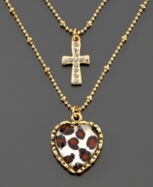 A twist on traditional. A textured goldtone cross pendant and heart-shaped leopard pendant dangle on a delicate double-layered chain. Length measures 16 inches; drop measures 1 inch.