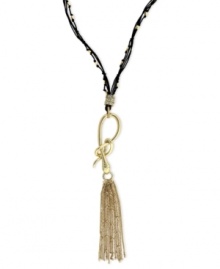 Slip into something new. Jessica Simpson's necklace is crafted from gold-tone mixed metal with a stylish tassel pendant. A snake motif adorns the black chord for a bit of an edge. Approximate length: 28 inches + 6-inch drop.