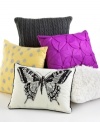 A fluttering butterfly adorns this decorative pillow in chic black and ivory hues for a stylish addition anywhere in your home.