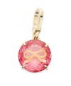 Juicy Couture's pretty charm features a round-cut solitaire pink epoxy stone engraved with a small bow. Set in a four prong gold tone brass setting. Lobster clasp closure. Approximate drop: 1-1/2 inches.