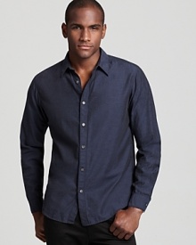 Urbane sophistication is embodied in a navy woven slim fit shirt from Theory.