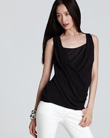 Artful draping lends feminine ease to this DNKY top, a chic topper for this season's statement denim and printed pants.