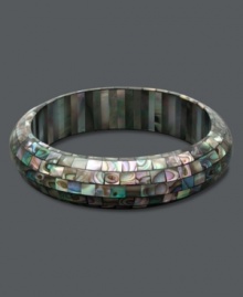 Like a beautiful piece of artwork, this stunning slip-on bangle combines tiny pieces of Mother of Pearl in a unique mosaic pattern. Approximate length: 7-1/2 inches.