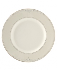 Sprinkled with subtle, stylized florals and wrapped in polished platinum bands, this bread & butter plate brings refined whimsy to your formal table in creamy fine bone china.