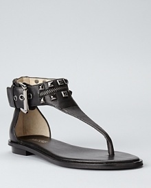 Punky studs lend tough-girl flair to a pair of otherwise-feminine sandals from MICHAEL Michael Kors.