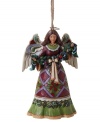 A peace offering for your tree, this beautiful angel ornament is draped with a lush garland of fruit and holly. Elaborate folk-art details in her skirt and rich colors throughout make it a Jim Shore classic.