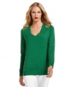 Shoulders full of shiny golden grommets gives this striking green sweater from MICHAEL Michael Kors chic appeal.