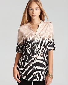 Emboldened by a graphic zebra print, this Calvin Klein top lends exotic inspiration to your everyday look. Finish with tribal accents and take charge of the fashion pack.