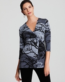 Lined with a seamless lockstitched shapewear tank to slim the figure, this Miraclebody by Miraclesuit top flaunts a pretty branch print and a crossover neckline for a flirtatious silhouette.