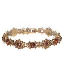 Elevate your ensemble with rich sparkle in golden hues. Monet bracelet features smoky topaz-colored glass stones set in an intricate gold tone mixed metal setting. Approximate length: 7-1/2 inches.