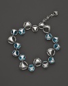 A bold sterling silver bracelet, gleaming with blue quartz , is an elegant showcase for Di MODOLO's iconic Triadra design.