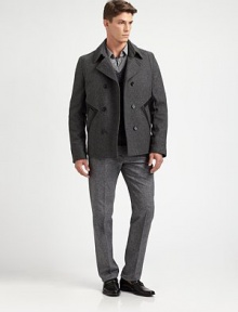 A double-breasted outerwear silhouette crafted in a superior wool blend, featuring leather pocket detailing for a uniquely tailored finish.Button-frontWaist slash pocketsFully linedAbout 27 from shoulder to hem80% wool/20% polyamideDry cleanImported