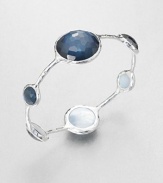 From the Wonderland Collection. Round faceted indigo doublet stations in various sizes set on a hammered sterling silver bangle. Indigo doubletSterling silverDiameter, about 2.5Slip-on styleImported 