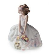 Flower girl. With a basket full of blooms and a pretty gown of exquisite porcelain, this sweet Lladro figurine recalls a girl's first wedding or special Easter moment.