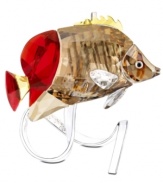 Far from the reef, this exquisite butterflyfish is captured in brilliant Swarovski crystal. Gold, copper and red tones shimmer much like they would under water while a silvertone branch with embossed coral captures the gentle movements of the sea.