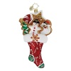 Festive cookies accented in glitter are stashed in a candy cane adorned stocking.