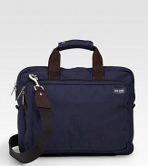 A soft briefcase fit for the streets, office and classroom alike in rugged denier canvas with a convenient laptop compartment and ripstop lining. Zip closure Exterior zip pocket Interior computer sleeve and organizing pockets Top handles, 4 drop Adjustable, detachable shoulder strap, about 44 15½W X 12H X 2D Imported 