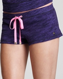 A pink ribbon drawstring pops against the over-dyed purple of these soft jersey shorts from Juicy Couture.