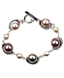 Smart mauve. With its versatile style that works for weekdays and weekends, investing in Givenchy's fashionable flex bracelet is a wise decision. Embellished with glass pearls in a pretty purple hue, it's set in silver tone mixed metal. Includes a toggle closure. Approximate length: 7-1/4 inches.