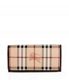 With its characteristic check and plentiful pockets, Burberry Londons continental wallet is an iconic way to keep your most valuable essentials organized - Haymarket check coated canvas, chocolate leather trim and lining, flap with snap closure, back slot pocket, multiple credit card slots inside, zippered coin purse - Carry alone for running quick errands, or stash away in a sophisticated leather tote