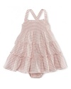 A charming smocked sundress is rendered in striped cotton jersey and finished with a ruffled hem.