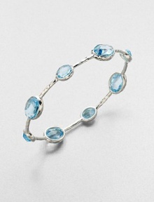 From the Rock Candy Collection. A graceful bangle of sculptural sterling silver is dotted with richly faceted ovals of dinsinctively hued blue topaz.Blue topazSterling silverDiameter, about 2.6Imported