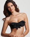 Ruffles lend ladylike style to this solid black swim top from Ella Moss.