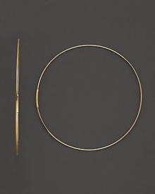 A graceful hoop in yellow gold and invisible closure to create a perfectly elegant orb to complement your most refined ensembles. Designed by Lana.