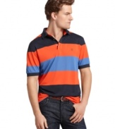 It only seems like you work hard at looking good with this lightweight, striped performance polo shirt from Izod.