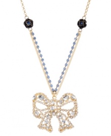 Top off your look to complete the package. Betsey Johnson's ultra-feminine pendant features a crystal-encrusted bow strung from a blue crystal cup chain with flower charm accents. Set in gold-plated mixed metal. Approximate length: 16 inches + 3-inch extender. Approximate drop: 2 inches.