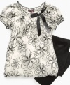 Sparkly flowers and a bubble shape make this cute Tempted tunic and leggings set totally groovy.