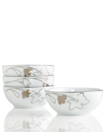 Wildflowers take off on glazed white porcelain, sparkling as they tumble aimlessly around Platinum Silhouette berry bowls. A banded edge adds a classic touch to a pattern with modern spirit.