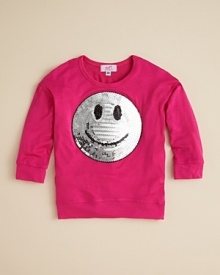 Smile! Sofi's adorable sweatshirt shines it on with a sequin smiley face.