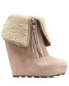 Nothing says cozy-chic like Ash's snow-capped wedge booties. Wrapped in suede and shearling, they're cool with denim, elegant with slim skirts.