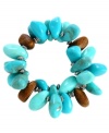 A must-have for your spring and summer collection. Haskell's vivid bracelet slips on effortlessly and brings vivacity to your look with bright turquoise and brown acrylic beads mixed with silver tone spacers. Bracelet stretches to fit wrist. Approximate length: 7-1/2 inches.