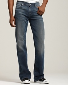 These classic 7 for All Mankind bootcut jeans in a faded wash fit low on the waist, slim through the thigh, then widen into a bootcut opening. The back pockets features the signature squiggle.