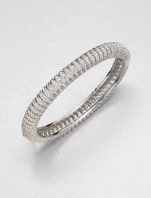 Neat rows of shimmering crystal line up along a slender bangle to wear alone or stack with others.CrystalRhodium platingDiameter, about 2.25Hinged with tongue-and-groove claspImported