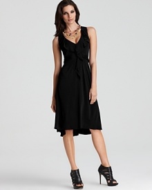 A flirtatious and flowing silhouette from Elie Tahari exudes feminine flair with a ruffled neckline.