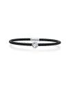 This striking 18K white gold and black cable bracelet, studded with a glittering white topaz station, is perfect for stacking.