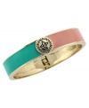 Capture the essence of colorblocking with bold contrasting colors. BCBGeneration's trendy bangle bracelet combines pink and aqua enamel in gold tone mixed metal. Features a slip-on hinge clasp. Approximate diameter: 3 inches.